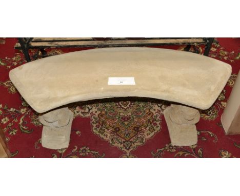 Garden ornaments - a reconstituted stone bench, arced seat, squirrel shaped end supports.