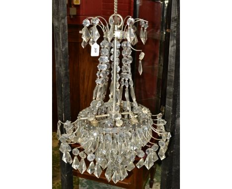 A mid 20th century cut glass droplet chandelier, arch body suspending four graduated rings, glass droplets and swags