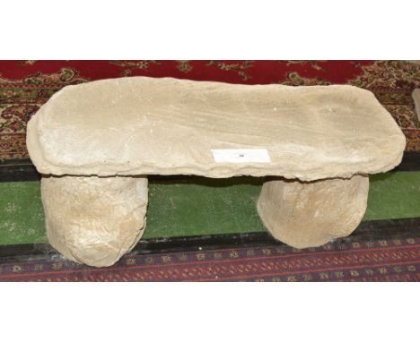 Garden ornaments - a reconstituted stone bench, rustic rectangular top, faux tree trunk supports.