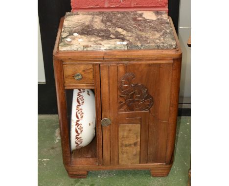 An Art Deco walnut, olive wood and mahogany marble topped bedside washstand, short drawer over washbowl recess, adjacent carv