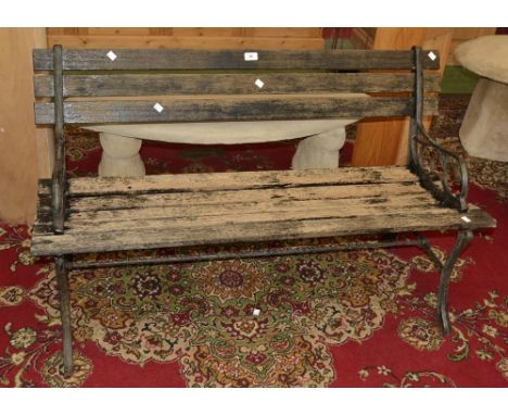 A garden bench ornate ends wooden slats 