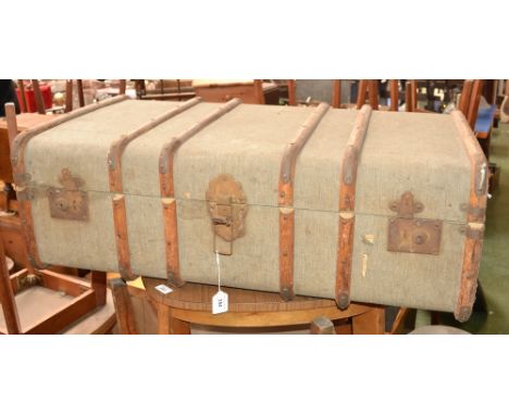 A wood bound steamer trunk; a Persian type rug, floral decoration on red ground, 131cm x 88cm (2)