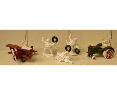 Reproduction cast iron Michelin advertising figures including a plane, a tractor and Michelin men (5)