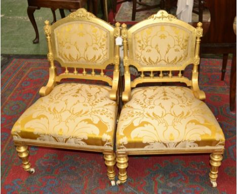 Two Louis XVI revival giltwood nursing chairs, carved cresting top rail, padded back, turned uprights, stuffed-overseat, turn