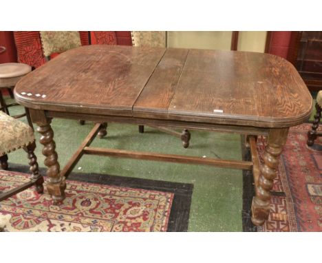 An oak D-end extending dining table, barley twist legs, ceramic casters. 73.5cm high x 107cm wide x 136cm long extending to 1