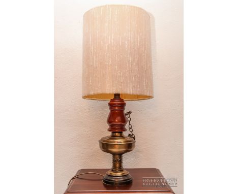 A wood and brass oil lamp, converted to an electric table lamp, with shade