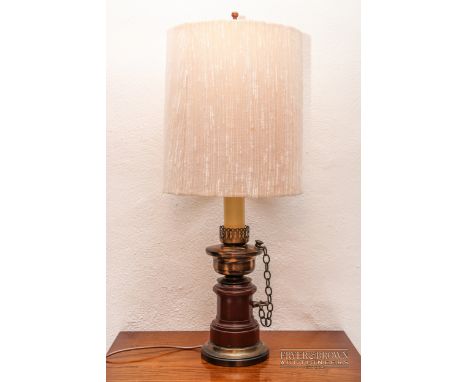 A wood and brass oil lamp, converted to an electric table lamp, with shade