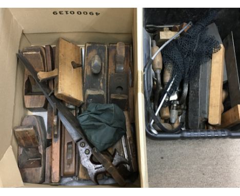 A collection of vintage woodwork tools including wooden planes, saws and other tools