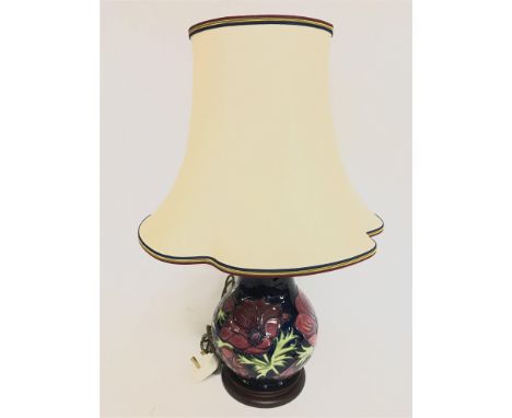 A moorcroft Anemone pattern lamp and shade 60cm tall. No obvious damage or restoration This lot cannot be posted