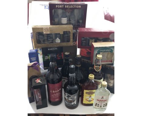 A box collection of bottles of Rum 1l and 70cl presentation boxes of small bottles of Port and other spirits including Vodka.
