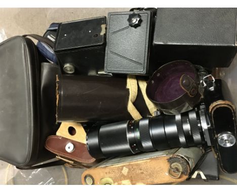 A collection of vintage cameras including an Asahi Pentax Spotmatic, Canon EOS 630, Vivitar Tele-Zoom 90-230mm lens, box came