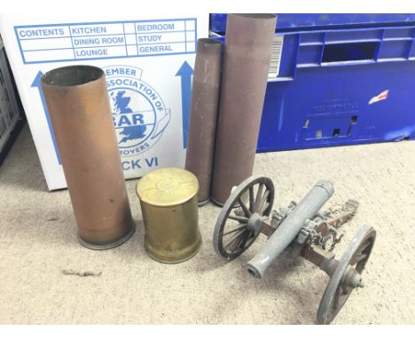 A collection of shell cases and a model canon. Postage category D