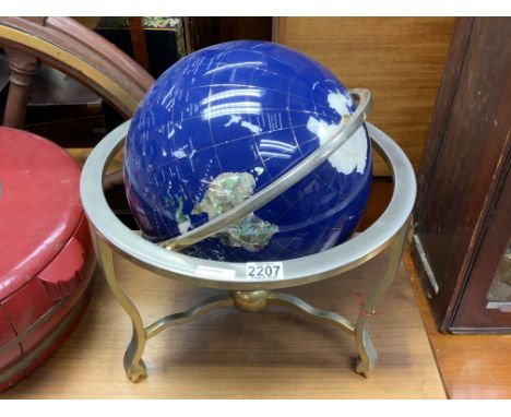 A modern terrestrial globe inlaid with semiprecious stones etc