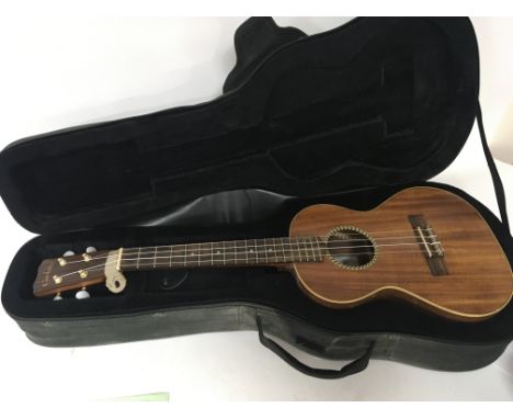 A cased Ukulele guitar maker Cordoba model 25TK in a fitted case.