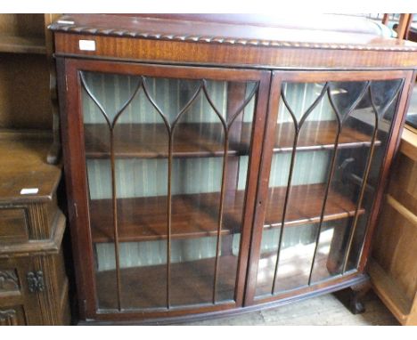 A mahogany bow front china display cabinet with astral glazed doors