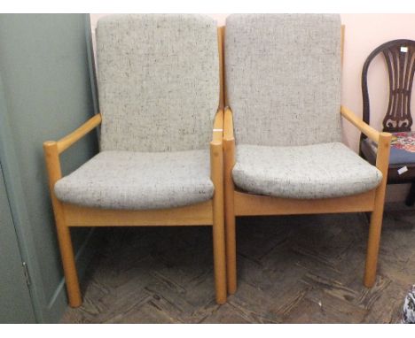 A pair of light Ercol beech armchairs in beige upholstery 