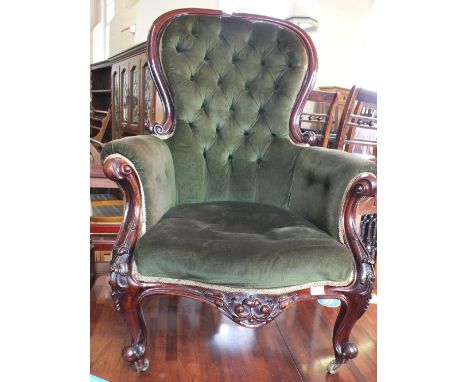 A Victorian carved mahogany armchair with green draylon button back upholstery