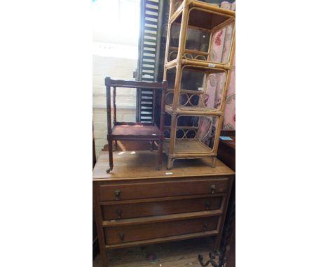 An oak chest of three long drawers, a wrought iron standard lamp, a bamboo whatnot and a small mahogany two tier trolley
