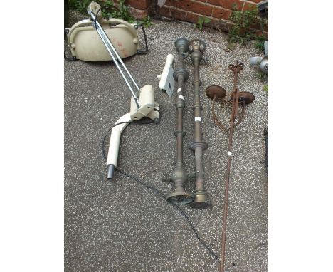 A de-commissioned dentist's lamp, an iron candelabra and two brass pipes