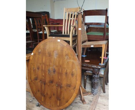 A pair of elbow chairs, a standard lamp, an oval tilt top table plus one other chair