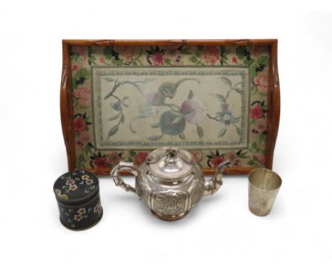 A CHINESE WHITE METAL TEAPOT Cast with panels of flowers,21cm wide,a white metal tumbler engraved with flowers,stamped marks,