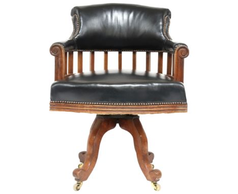 AN EARLY 20TH CENTURY BEECH FRAMED CAPTAINS STYLE SWIVEL DESK CHAIR&nbsp; with black Rexine upholstered comb back and seat on