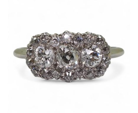 AN OLD CUT DIAMOND CLUSTER RING mounted in yellow and white metal, set with three principal diamonds with the estimated appro