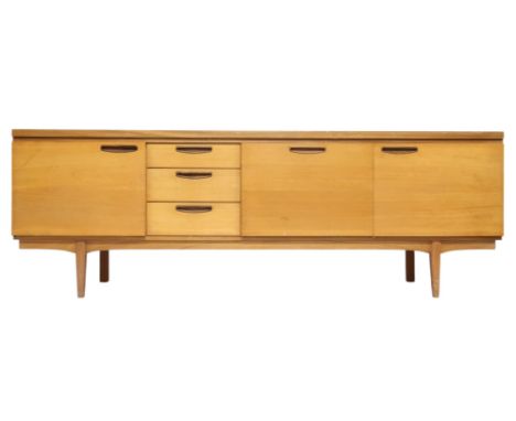 A MID 20TH CENTURY TEAK GREAVES AND THOMAS SIDEBOARD&nbsp; with three graduating drawers and fall front drinks compartment fl