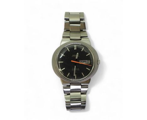 AN OMEGA AUTOMATIC GENEVE DYNAMIC with a black dial and day date aperture, silver coloured baton numerals and hands with red 