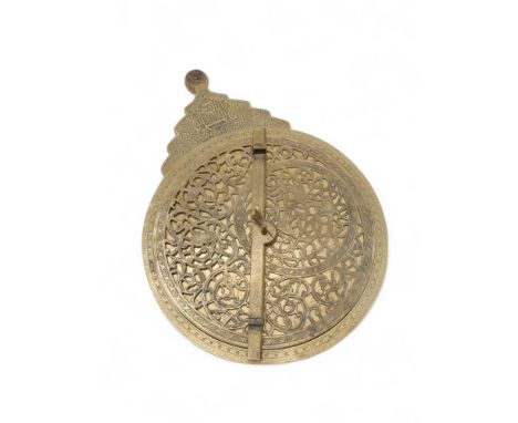 A PERSIAN BRASS FOUR PLATE ASTROLABE 19th century, 31cm diameter, with engraved mater with limb marked in degrees, the rotati