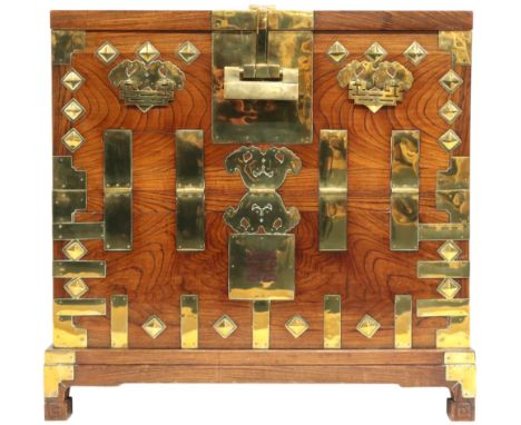A 20TH CENTURY KOREAN ELM AND BRASS MOUNTED BANDAJI CHEST with hinged fall front door concealing three over two short drawers