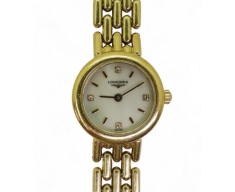 A LADIES LONGINES WRISTWATCH made in 18ct gold with mother of pearl dial, diamond quarters and further gold baton numerals an
