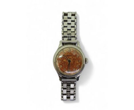 A LONGINES AUTOMATIC&nbsp; cased in stainless steel, with an aged patinated dial, Arabic numerals and blued steel hands. With