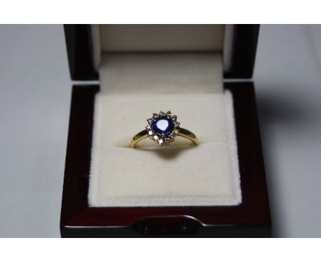 A SAPPHIRE AND DIAMOND RING, with triangular shape sapphire within a surround of single cut diamonds, hallmarks rubbed, chip 