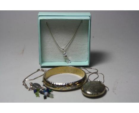 A SMALL COLLECTION OF JEWELLERY, to include a large locket, clasp bangle, two necklaces