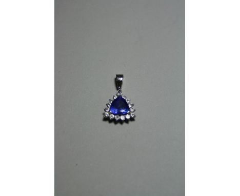 AN 18CT GOLD TANZANITE AND DIAMOND PENDANT, with trillian cut tanzanite to a surround of brilliant cut diamonds to a tapered 