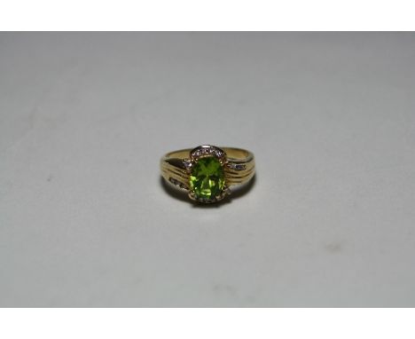 AN 18CT GOLD PERIDOT AND DIAMOND DRESS RING, with oval shape peridot and brilliant cut diamond surround, stamped 750, ring si