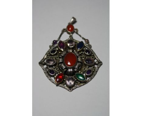 A LARGE MULTI-GEM PENDANT, with central cornelian within a surround of mixed gemstones, suspended from a further oval shape c