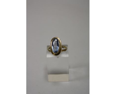 A 9CT GOLD TOPAZ RING, with oval shape topaz to plain tapered sides, ring size M