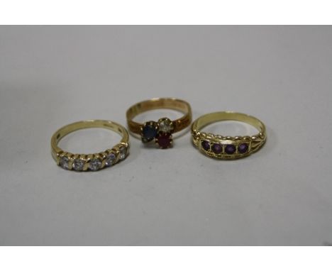 THREE RINGS, the first with sapphire, ruby and diamond in a club shape, a cubic zirconia ring, together with an amethyst ring