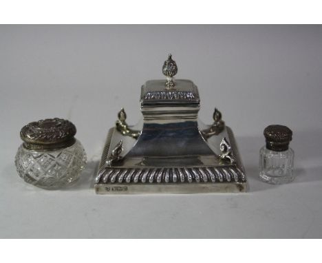 A SILVER CAPSTAN INKWELL, of swept square form with scroll mounts to corners and finial, Sheffield 1905, approximately 11.5cm