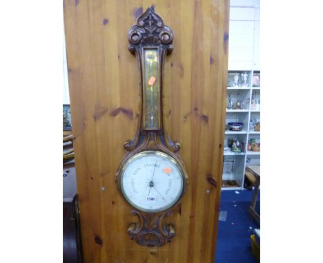 A CARVED OAK FRAMED BAROMETER, dial marked Heap, Burnley