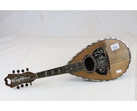 Antique mandolin with white metal and mother of pearl inlay
