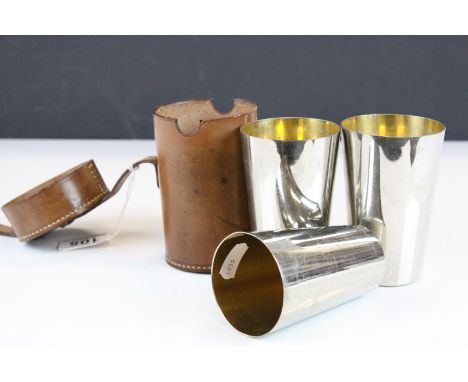 Early 20th century Leather cased set of three graduated gilt lined silver plated Hunting Beakers, 