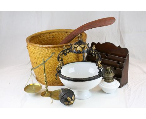 Wicker basket containing an antique cast iron hanging lamp with glass shade, a set of brass scales, an Aboriginal boomerang &