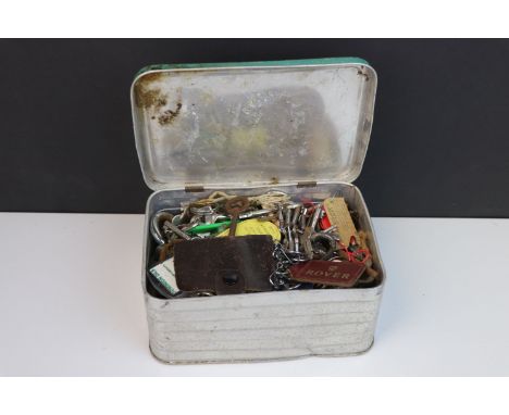A large quantity of vintage keys contained within a metal box.