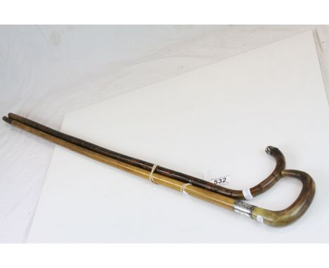 A antique malacca silver mounted walking stick with horn handle and one other walking stick.