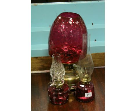 Antique brass oil lamp with cranberry dimpled shade &amp; two oil lamps with cranberry glass wells (3)