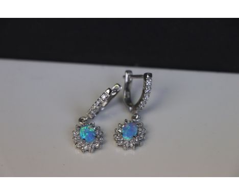 A pair of silver, cz and blue opal earrings