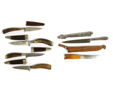 An Argentinian Gaucho Knife, each side of the 18cm single edge Inox steel blade etched with a cattle ranching scene, the silv